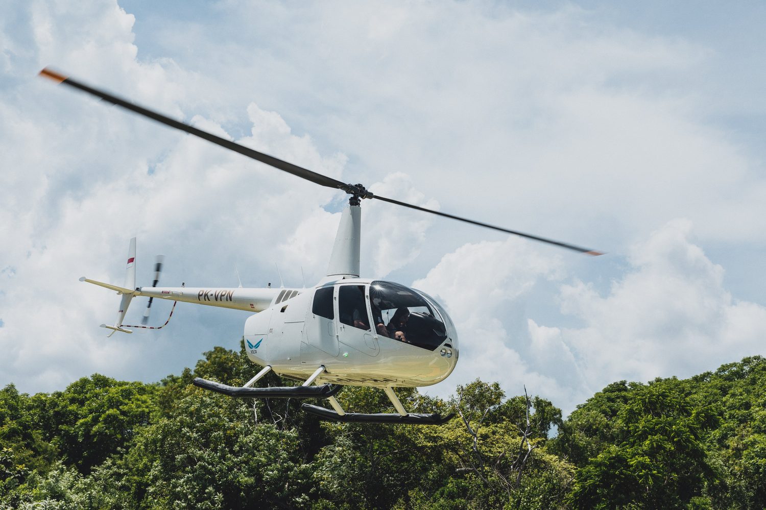 Robinson R66 helicopter in flight over Bali